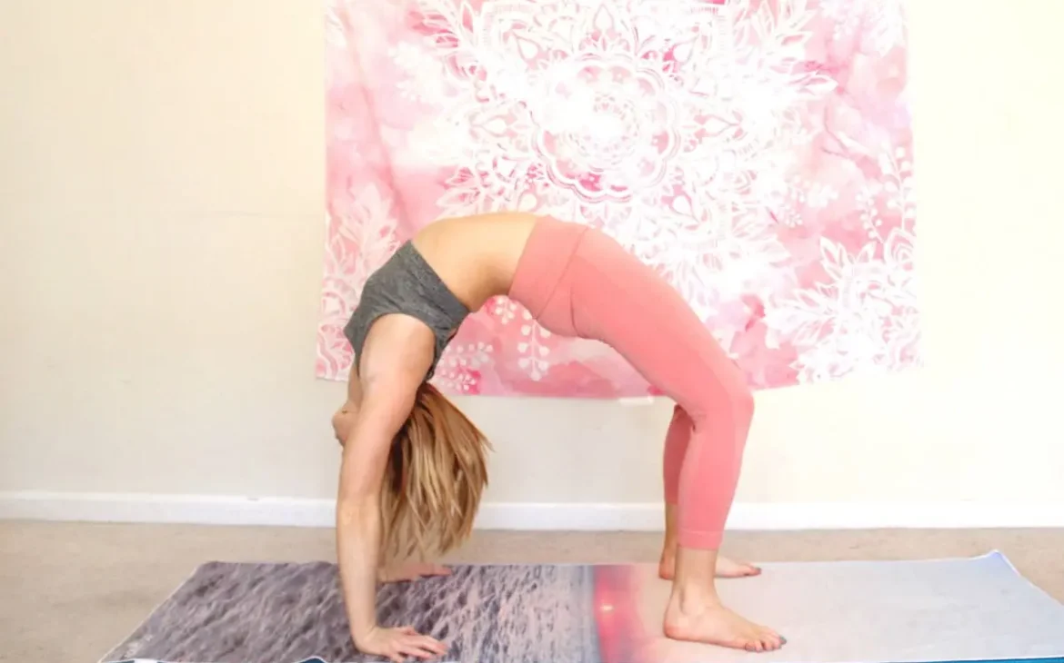 Woman doing wheel pose on a yoga mat
