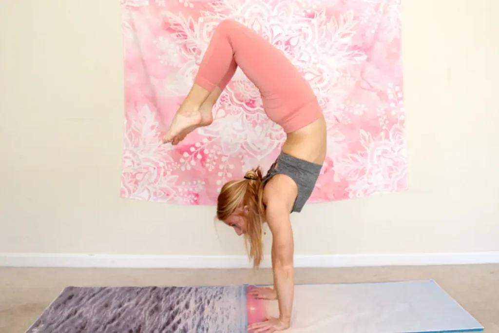 Woman doing a arched handstand with her feet approaching her head