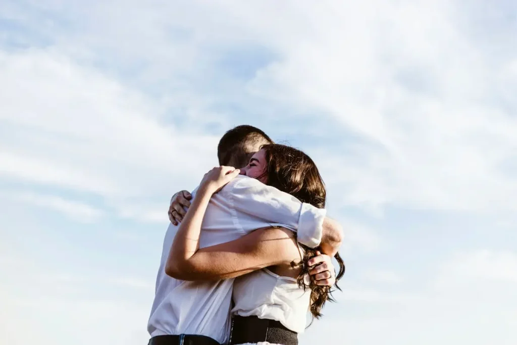 A couple embracing in a hug on a sunny day